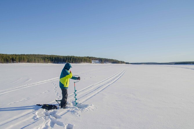 First Ice Fishing Experience in Rovaniemi - Drilling your first hole through the ice