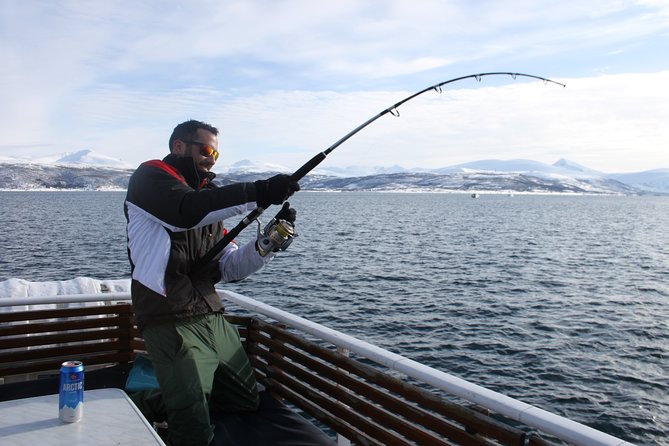 An angler working a bent rod over open water