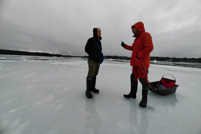 Ice fishing experience with Backpacker Helsinki Tour - Standing on a frozen lake