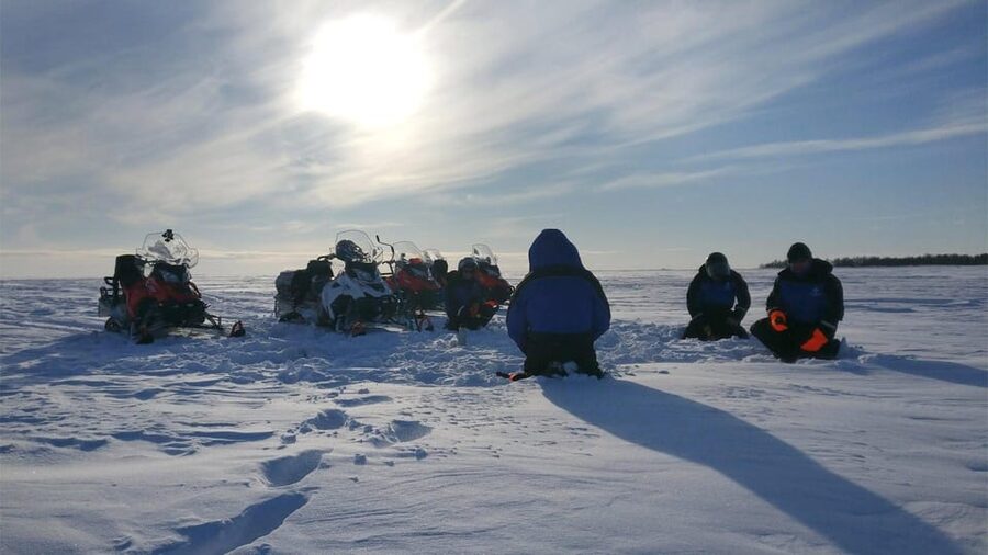 Kemi-Tornio: Ice Fishing Safari with Snowmobiles - Drilling a hole in the sea ice