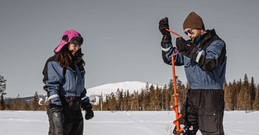 Saariselkä: Arctic Ice Fishing Experience - Drilling through the ice and setting the rod