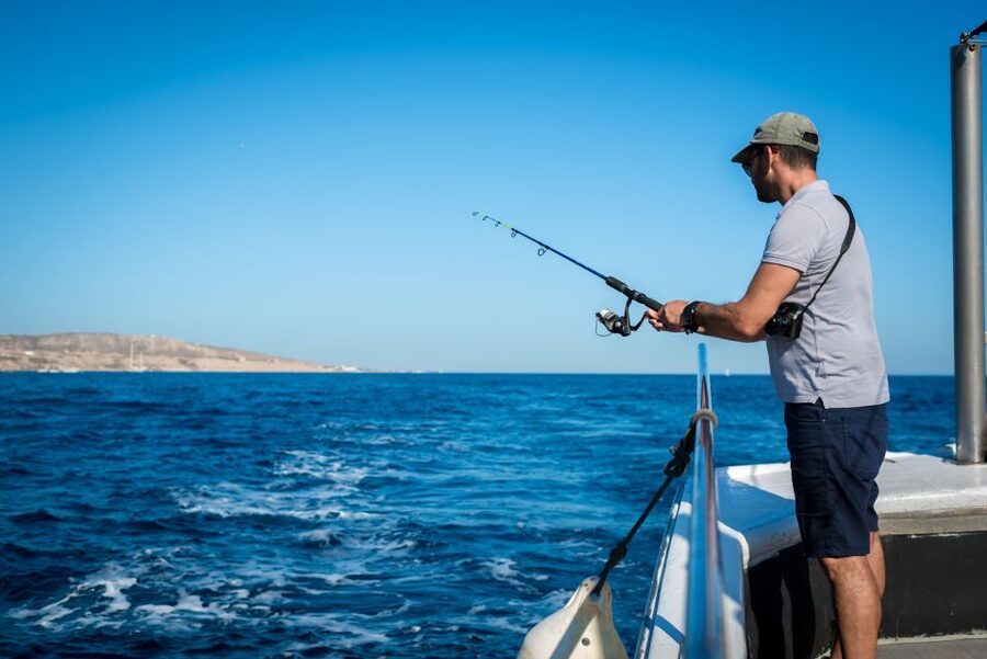 Santorini Sunset Fishing Trip with Dinner and Drinks - Cooking the catch and eating on board