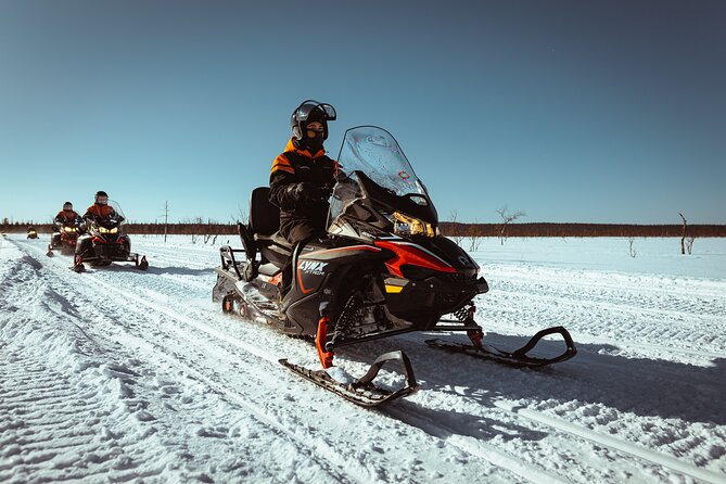 Snowmobile Safari with Ice Fishing and Outdoor Lunch in Levi - Learning how to fish through the ice